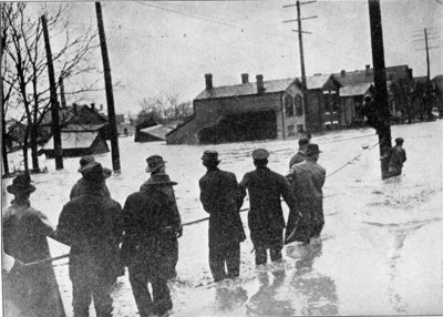 Life lines strung across one of the streets. The rescuers caught persons carried down on wreckage in the raging flood and brought them to a place of safety